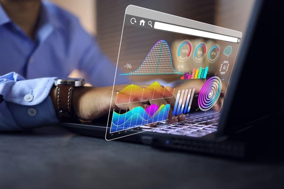 A conceptual image of a businessman analyzing data visualizations on his laptop.
