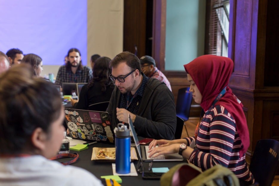 Students work on their laptops in a common student area